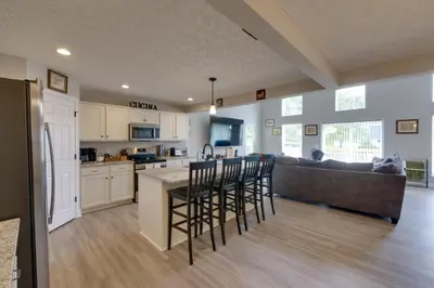 a kitchen and living room with a couch and a table at Hot Tub, Lake Access, and Dock Port Clinton Retreat in Port Clinton