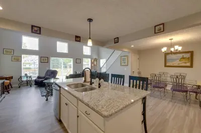 a kitchen with a sink and a living room at Hot Tub, Lake Access, and Dock Port Clinton Retreat in Port Clinton
