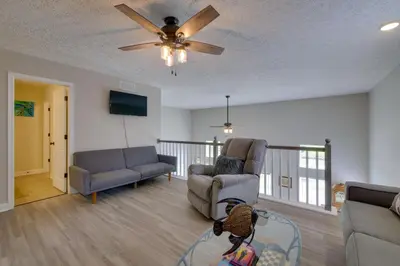 a living room with two chairs and a ceiling fan at Hot Tub, Lake Access, and Dock Port Clinton Retreat in Port Clinton
