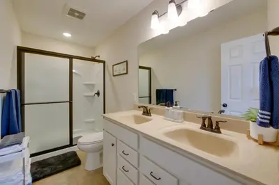 a bathroom with two sinks and a toilet at Hot Tub, Lake Access, and Dock Port Clinton Retreat in Port Clinton