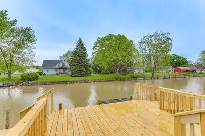 a wooden dock with a view of a river at Hot Tub, Lake Access, and Dock Port Clinton Retreat in Port Clinton