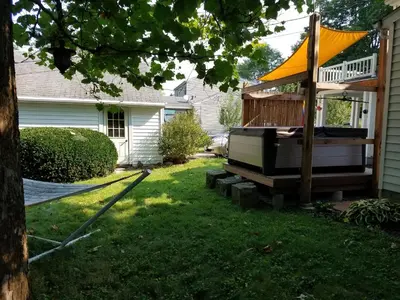 a backyard with a hot tub and a gazebo at 1936 Art & International Home in Lancaster