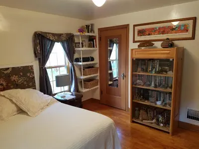 a bedroom with a bed and a book shelf at 1936 Art & International Home in Lancaster