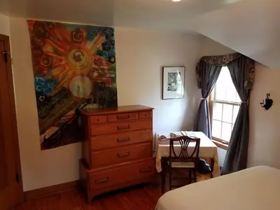 a bedroom with a dresser and a painting on the wall at 1936 Art & International Home in Lancaster