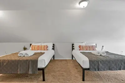 two beds sitting next to each other in a room at The Champion Abode 2 in Columbus