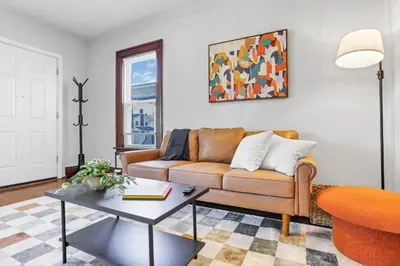 a living room with a couch and a table at The Champion Abode 2 in Columbus