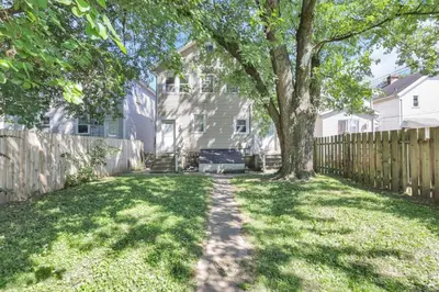 a yard with a tree and a fence at The Champion Abode 2 in Columbus
