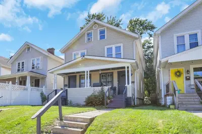a house with a yellow door and a house at The Champion Abode 2 in Columbus