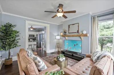 a living room with a couch and a flat screen tv at The Indiana Stunner in Columbus