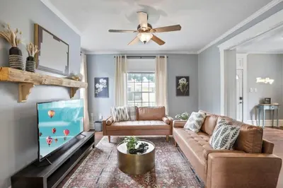 a living room with a couch and a flat screen tv at The Indiana Stunner in Columbus
