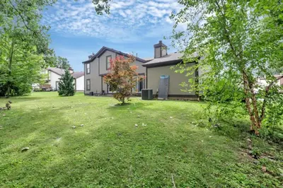 a house with a grass yard in front of it at The Highmeadow Retreat in Gahanna