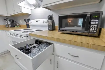 a kitchen with a microwave oven and a stove at The Highmeadow Retreat in Gahanna