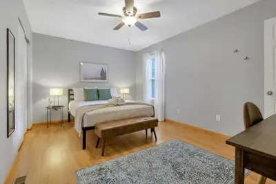 a bedroom with a bed and a ceiling fan at The Highmeadow Retreat in Gahanna