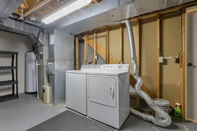 a washing machine in a room with a hose at The Highmeadow Retreat in Gahanna