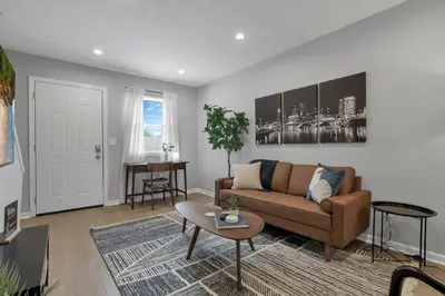 a living room with a couch and a table at The Schumacher Townhouse - 2 BR in Columbus