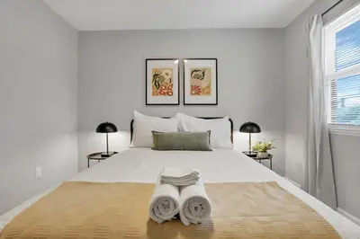 a bedroom with a bed with two towels on it at The Schumacher Place - NEW 2 BR in Columbus