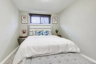 a bedroom with a large white bed with a window at 5 Mi to The USAF Museum Dayton Home, Walk to Park in Dayton