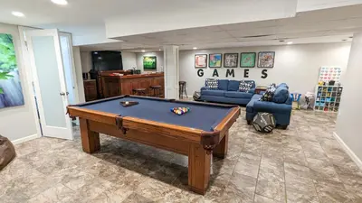 a living room with a pool table in it at 5 Bedroom Family Gathering Home with Indoor Hot Tub in Huron