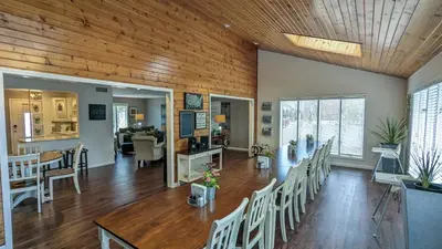 a dining room and living room with a table and chairs at 5 Bedroom Family Gathering Home with Indoor Hot Tub in Huron