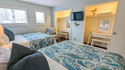 a hotel room with two beds and a desk at 5 Bedroom Family Gathering Home with Indoor Hot Tub in Huron