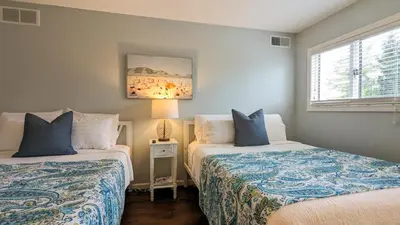 a bedroom with two beds and a window at 5 Bedroom Family Gathering Home with Indoor Hot Tub in Huron
