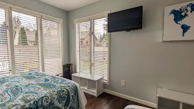 a bedroom with a bed and a flat screen tv at 5 Bedroom Family Gathering Home with Indoor Hot Tub in Huron