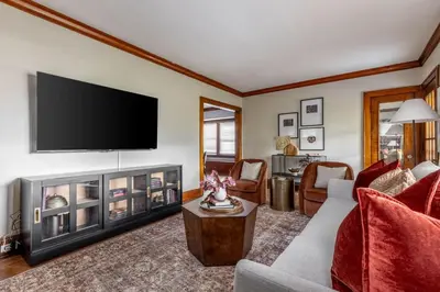 a living room with a fireplace and a flat screen tv at Stunning 3BR - Near Cleveland Clinic Main Campus in Cleveland Heights