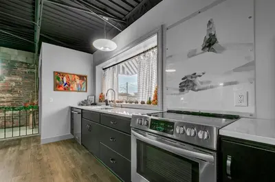 a kitchen with a stove and a sink at The 418. An 1866 Build with Modern Comforts in Fort Wayne