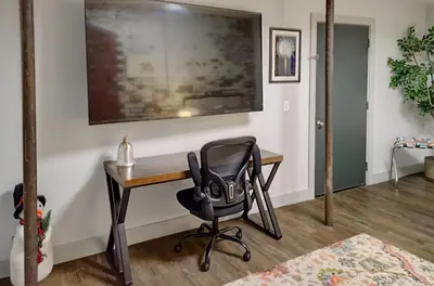 a office with a desk and a chair at The 418. An 1866 Build with Modern Comforts in Fort Wayne