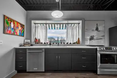 a kitchen with a large sink and a window at The 418. An 1866 Build with Modern Comforts in Fort Wayne