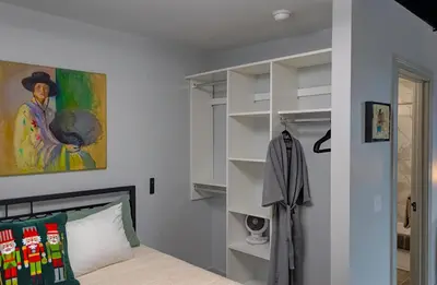 a bedroom with a bed and a painting on the wall at The 418. An 1866 Build with Modern Comforts in Fort Wayne
