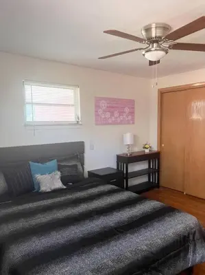 a bedroom with a large bed and a ceiling fan at Cozy 2 Bedroom in Cleveland in Cleveland Heights