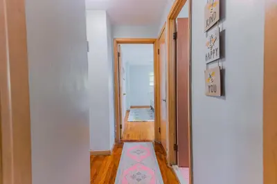 a hallway with a rug on the floor and a door at Charming 2 Bed Room in Cleveland in Cleveland Heights