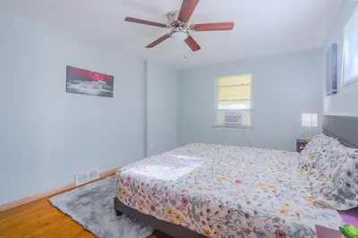 a bedroom with a bed and a ceiling fan at Charming 2 Bed Room in Cleveland in Cleveland Heights