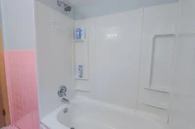 a bathroom with a shower with pink tile at Charming 2 Bed Room in Cleveland in Cleveland Heights