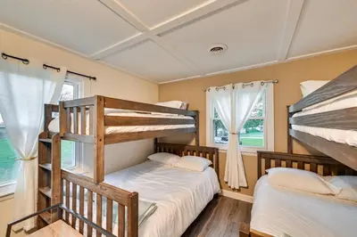 a bedroom with two bunk beds and a window at Dry Ridge Rental Home with Hot Tub and Game Room! in Dry Ridge