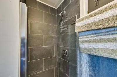 a bathroom with a shower with a glass door at Dry Ridge Rental Home with Hot Tub and Game Room! in Dry Ridge