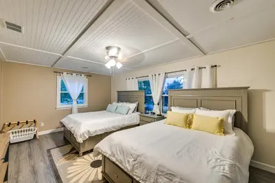 a bedroom with two beds and two windows at Dry Ridge Rental Home with Hot Tub and Game Room! in Dry Ridge