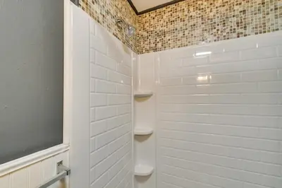 a bathroom with a shower with white tiles at Dry Ridge Rental Home with Hot Tub and Game Room! in Dry Ridge