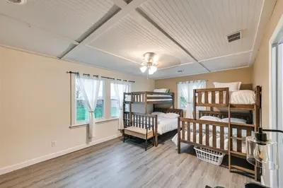 a room with three bunk beds and a ceiling at Dry Ridge Rental Home with Hot Tub and Game Room! in Dry Ridge