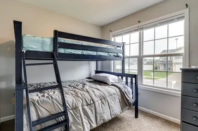 a bedroom with a bunk bed and a window at Cozy Ohio Home - Deck, Arcade Games and Near Golfing in Cincinnati