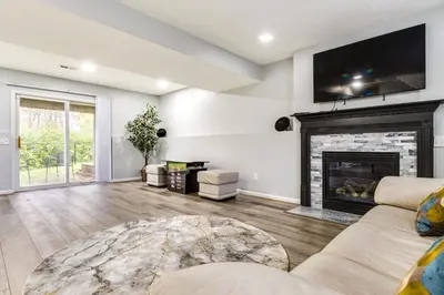 a living room with a fireplace and a tv on the wall at Cozy Ohio Home - Deck, Arcade Games and Near Golfing in Cincinnati