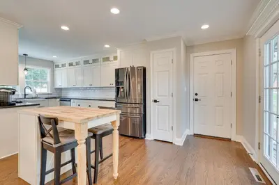 a kitchen with a wooden table and a refrigerator at Powell Home with Fire Pit - 5 Mi to Columbus Zoo! in Powell