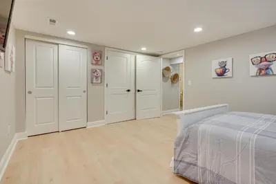 a white bedroom with white cabinets and a bed at Powell Home with Fire Pit - 5 Mi to Columbus Zoo! in Powell