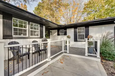 a house with a white fence and a porch at Powell Home with Fire Pit - 5 Mi to Columbus Zoo! in Powell