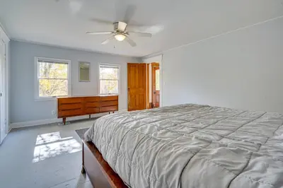 a bedroom with a bed and a dresser and a ceiling fan at Spacious and Inviting Jackson Getaway with Fireplace! in Jackson