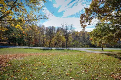 a field with leaves on the grass in a park at Spacious and Inviting Jackson Getaway with Fireplace! in Jackson