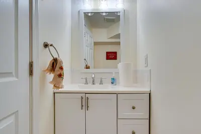 a white bathroom with a sink and a mirror at Spacious and Inviting Jackson Getaway with Fireplace! in Jackson