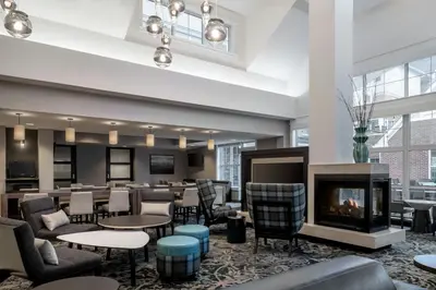 a lobby with a fireplace and tables and chairs at Residence Inn by Marriott Akron Fairlawn in Fairlawn