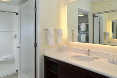 a white bathroom with a sink and a shower at Residence Inn by Marriott Akron Fairlawn in Fairlawn